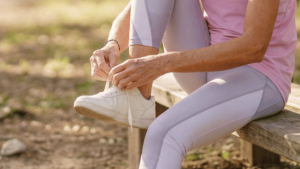 Active woman walking outdoors on a sunny path as part of her daily exercise for a healthy lifestyle routine.
