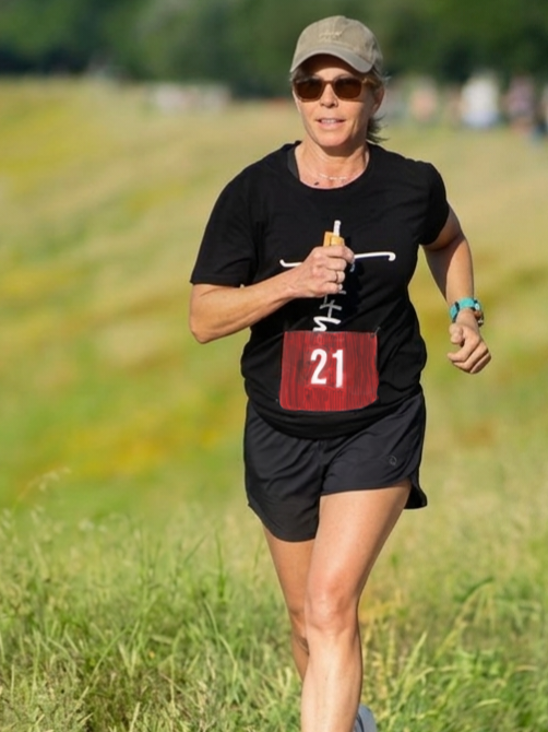 Laura S. Garrett running outdoors in her fifties as part of her longevity fitness routine.
